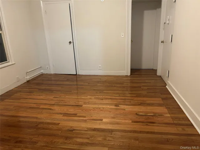a view of a room with wooden floor