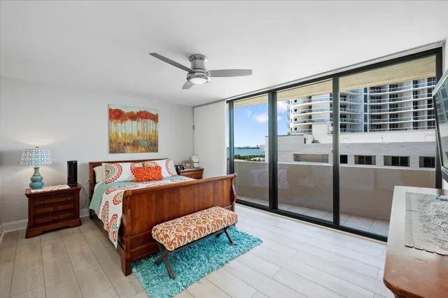 a bed room with a bed and a ceiling fan