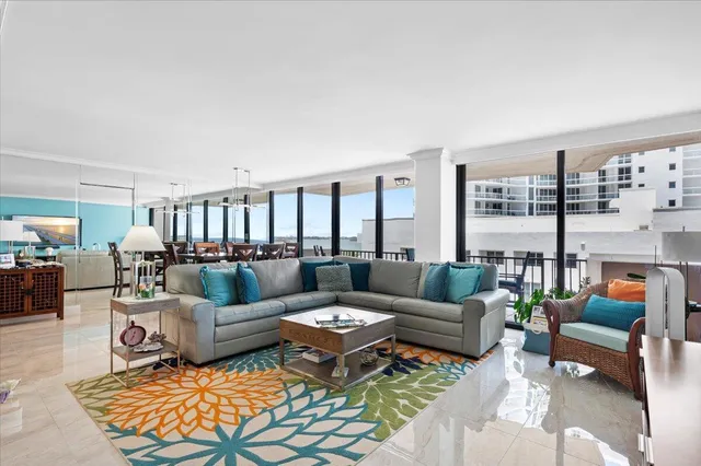 a living room with furniture a rug and a table