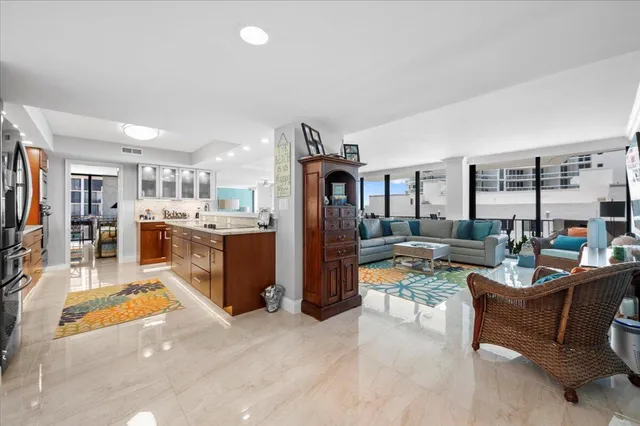 a living room with furniture and a kitchen