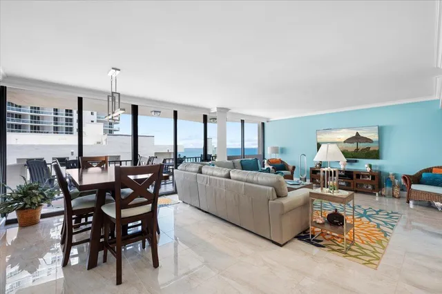 a living room with furniture and a dining table