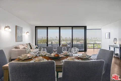 a room with furniture and large windows