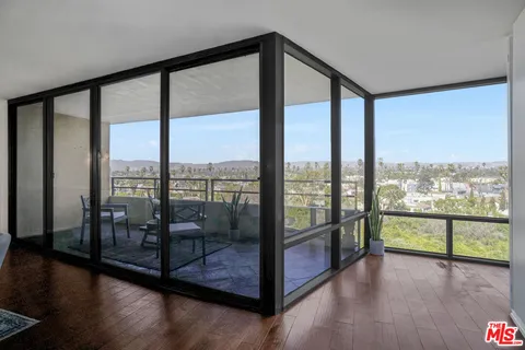 a view of a glass room with windows