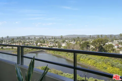 a view of city and mountain from a balcony