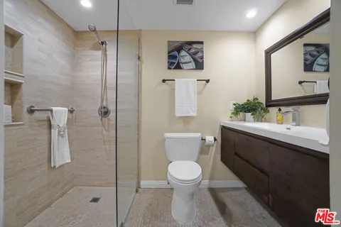 a bathroom with a toilet sink and shower
