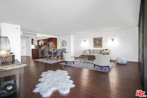 a living room with fireplace furniture and a wooden floor