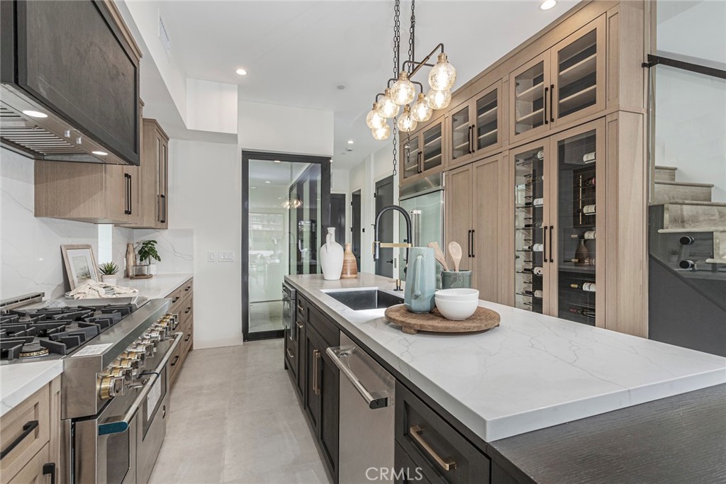 328 3rd Street Huntington Beach, CA 92648 - Photo 11 of 42 a kitchen with stainless steel appliances granite countertop a sink stove and refrigerator