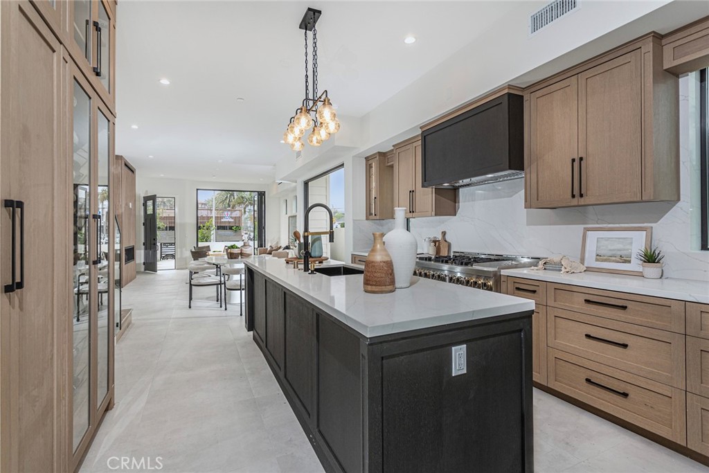 328 3rd Street Huntington Beach, CA 92648 - Photo 12 of 42 a kitchen with a sink dishwasher a stove and a refrigerator with wooden floor