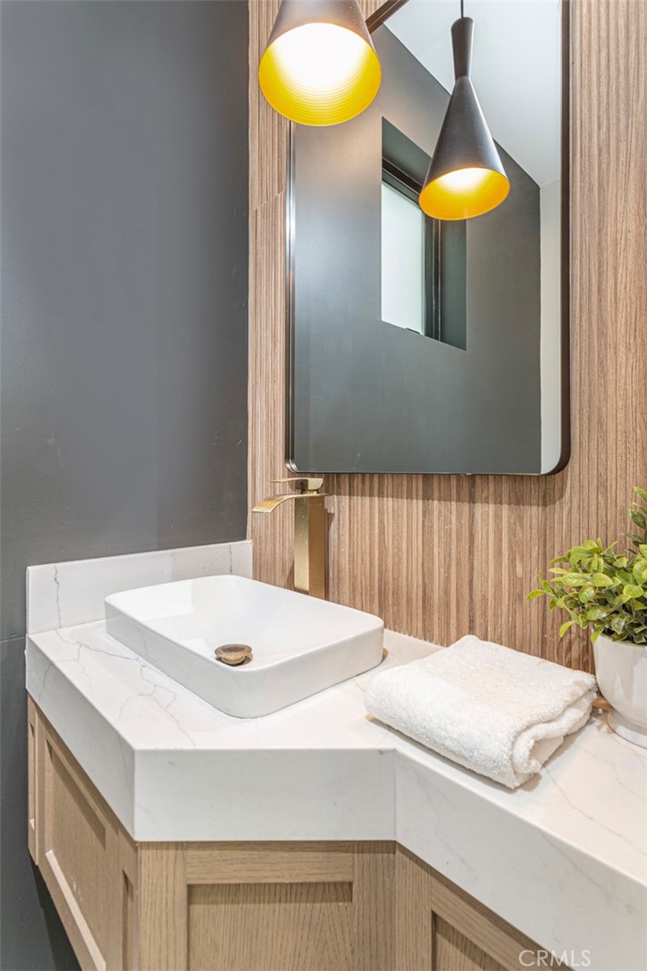 328 3rd Street Huntington Beach, CA 92648 - Photo 14 of 42 a bedroom with a bed and a chandelier