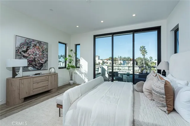 a large bedroom with a large bed and a large window