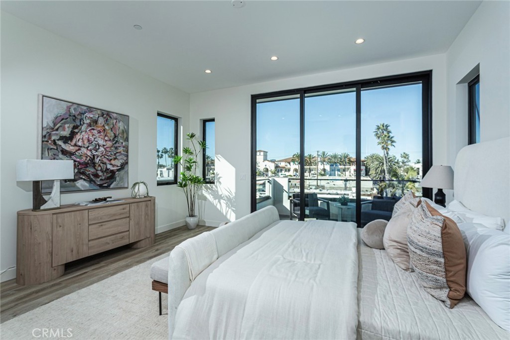 328 3rd Street Huntington Beach, CA 92648 - Photo 16 of 42 a large bedroom with a large bed and a large window