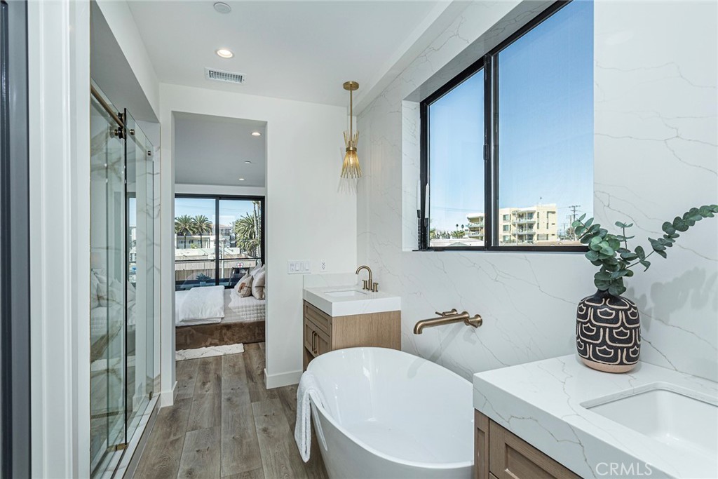 328 3rd Street Huntington Beach, CA 92648 - Photo 17 of 42 a bathroom with a granite countertop sink a toilet a mirror and shower