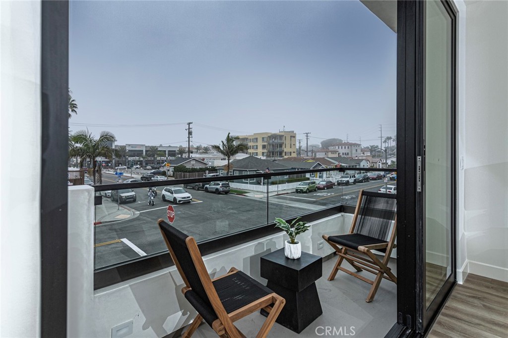 328 3rd Street Huntington Beach, CA 92648 - Photo 18 of 42 a view of a balcony with chairs