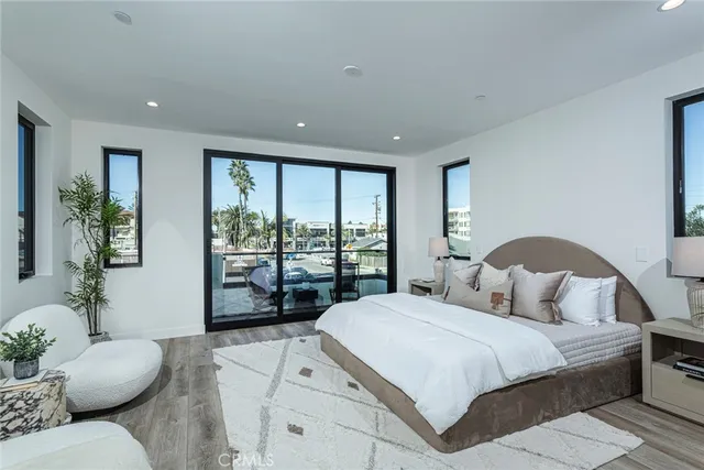 a bedroom with a large bed and a large window