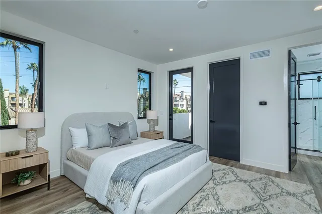 a bedroom with a large bed and a window