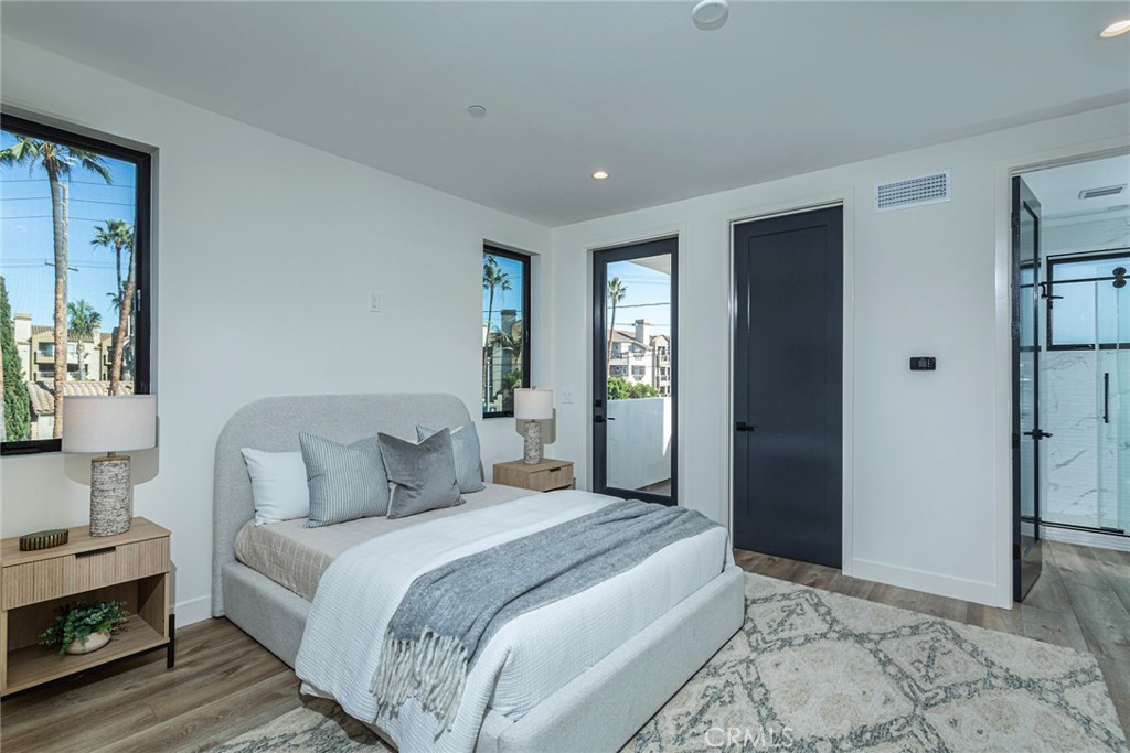 328 3rd Street Huntington Beach, CA 92648 - Photo 24 of 42 a bedroom with a large bed and a window