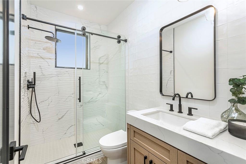 328 3rd Street Huntington Beach, CA 92648 - Photo 25 of 42 a bathroom with a sink toilet and shower