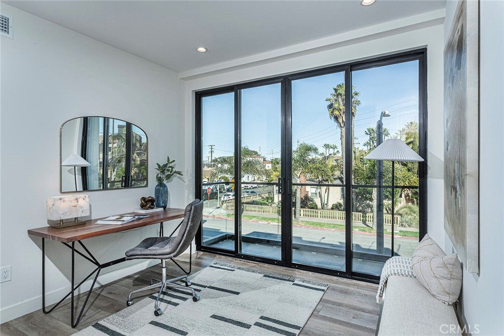 328 3rd Street Huntington Beach, CA 92648 - Photo 27 of 42 a living room with a large window and a table