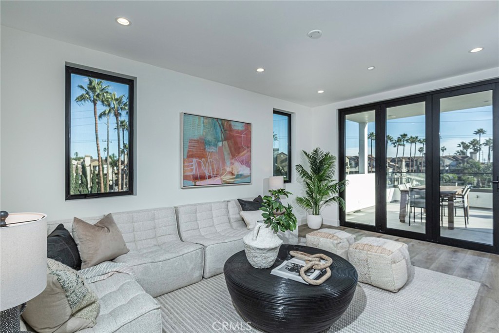 328 3rd Street Huntington Beach, CA 92648 - Photo 28 of 42 a living room with furniture potted plant and a large window