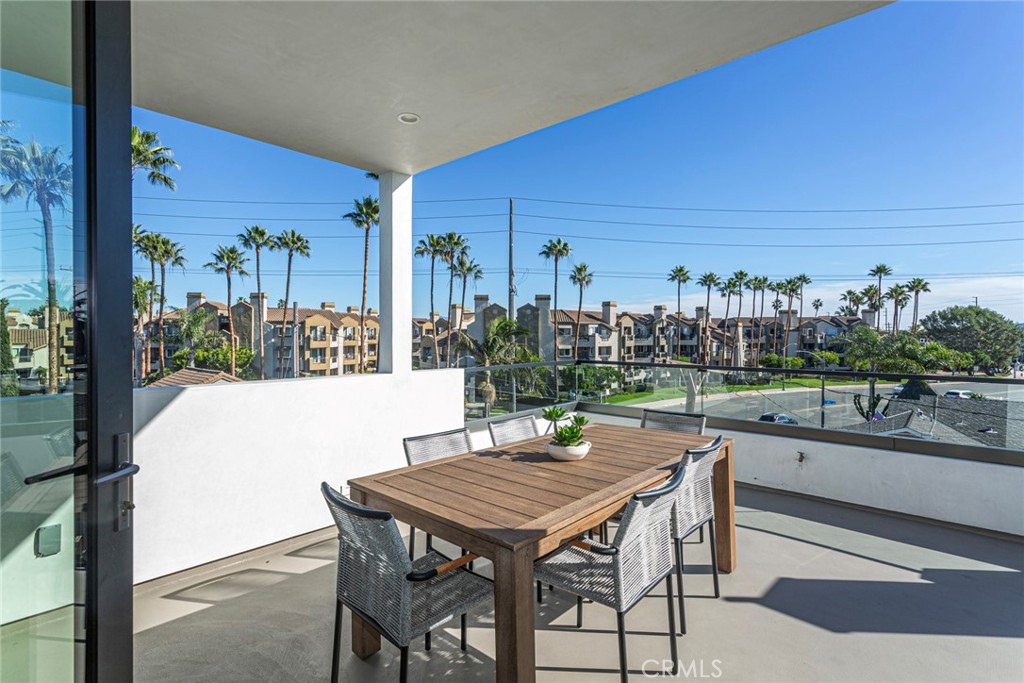 328 3rd Street Huntington Beach, CA 92648 - Photo 29 of 42 a view of a patio with a table and chairs