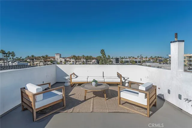 a terrace with outdoor seating and city view