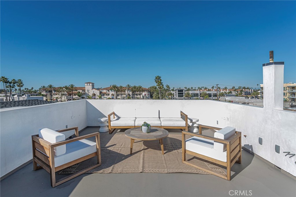 328 3rd Street Huntington Beach, CA 92648 - Photo 30 of 42 a terrace with outdoor seating and city view