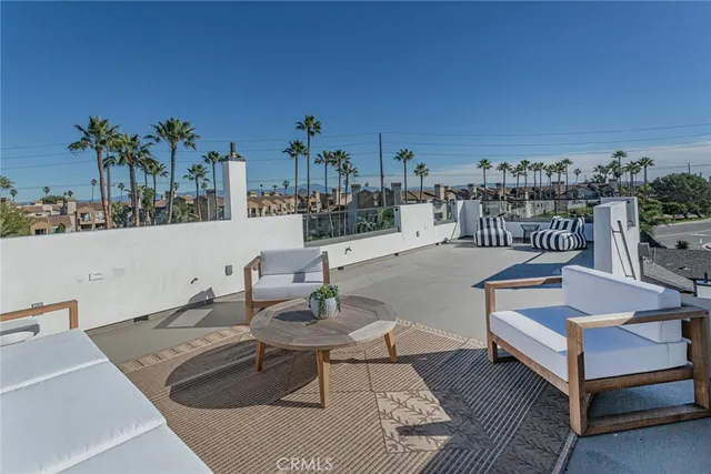 a terrace with outdoor seating and city view