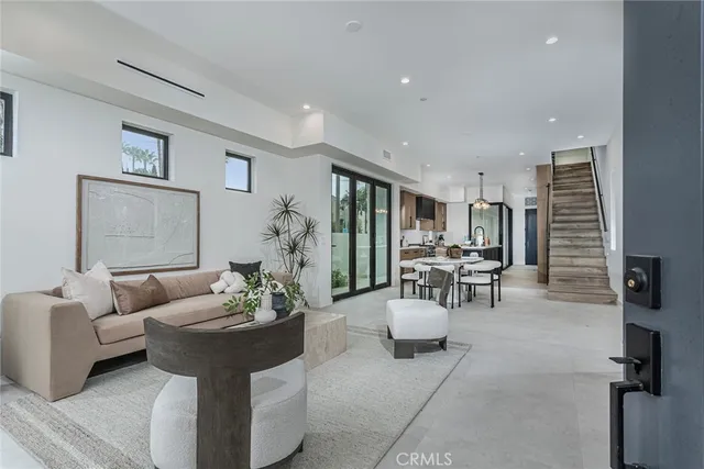 a living room with furniture and view of kitchen