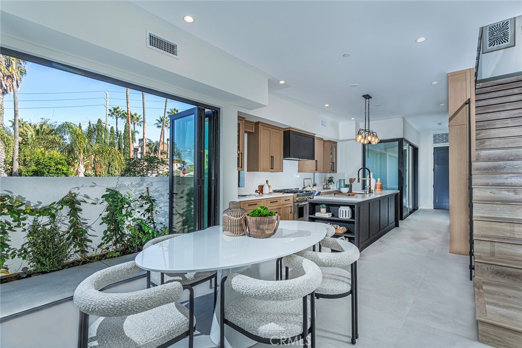 328 3rd Street Huntington Beach, CA 92648 - Photo 9 of 42 a kitchen with a table chairs and a living room view