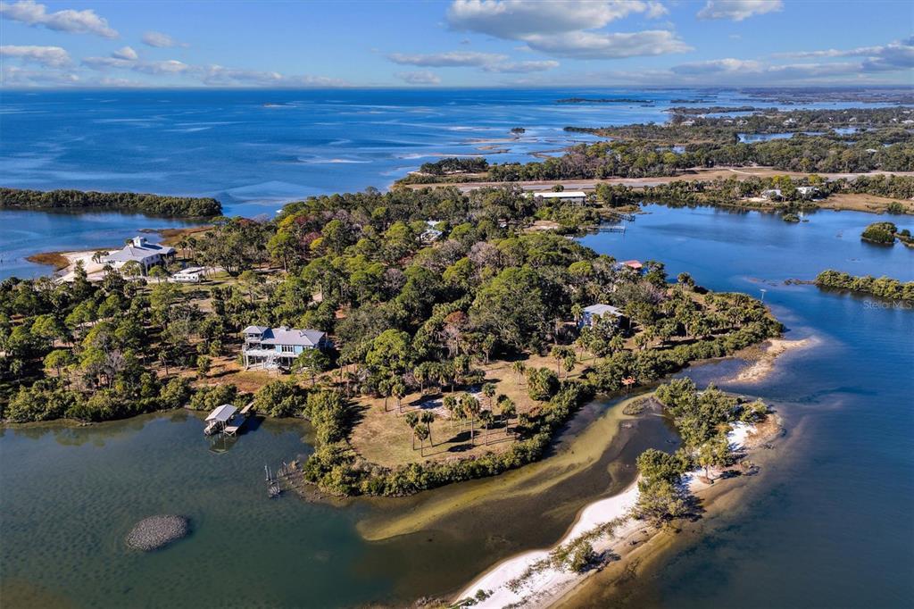 136 Southwest Sw Place Cedar Key, FL 32625 - Photo 3 of 13 view of a lake with houses