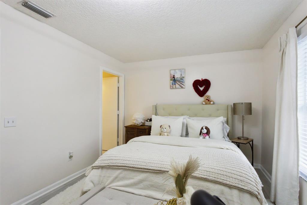 368 Waterside Drive Hypoluxo, FL 33462 - Photo 12 of 24 a bedroom with a bed and a window