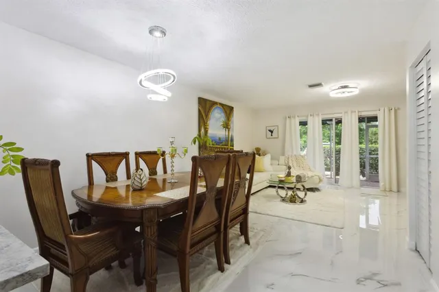 a view of a dining room with furniture and window