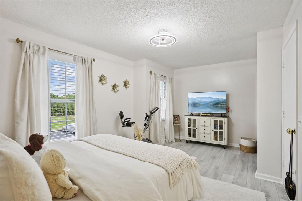 368 Waterside Drive Hypoluxo, FL 33462 - Photo 18 of 24 a bedroom with a bed and a flat tv screen on dresser