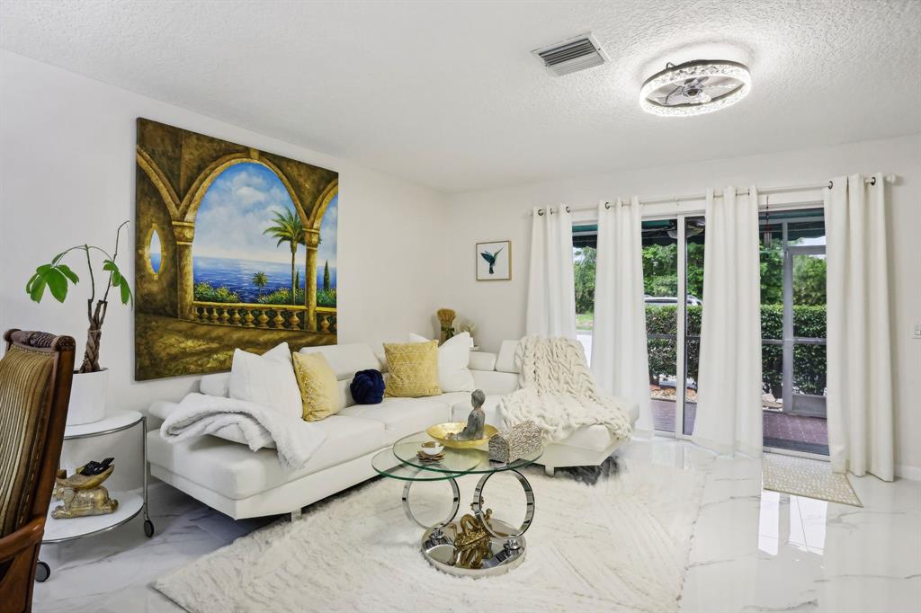 368 Waterside Drive Hypoluxo, FL 33462 - Photo 22 of 24 a living room with furniture and a large window