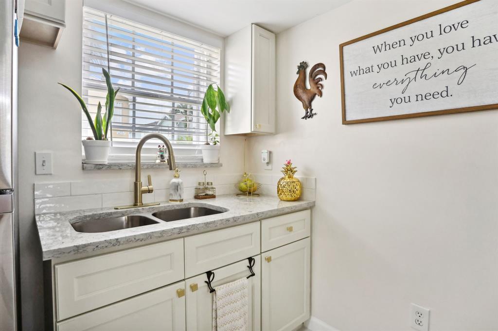 368 Waterside Drive Hypoluxo, FL 33462 - Photo 23 of 24 a kitchen with a sink and a window