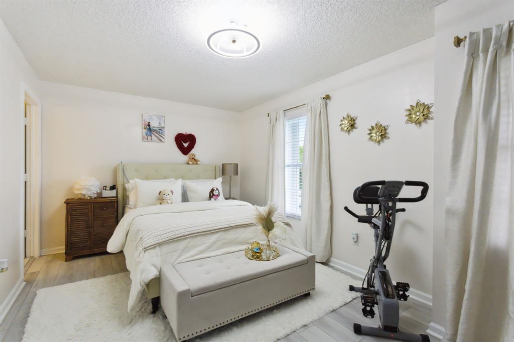 368 Waterside Drive Hypoluxo, FL 33462 - Photo 4 of 24 a bedroom with a bed and a chandelier