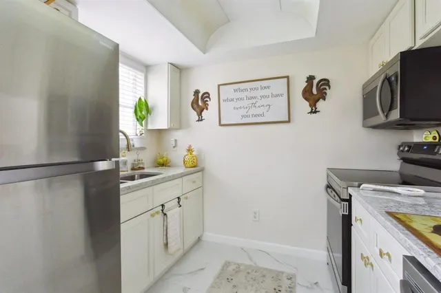 a kitchen with a sink and a refrigerator