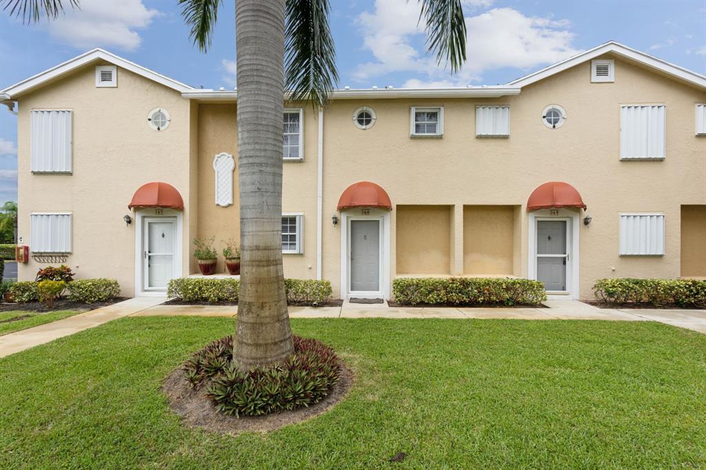 368 Waterside Drive Hypoluxo, FL 33462 - Photo 9 of 24 a front view of a house with a yard