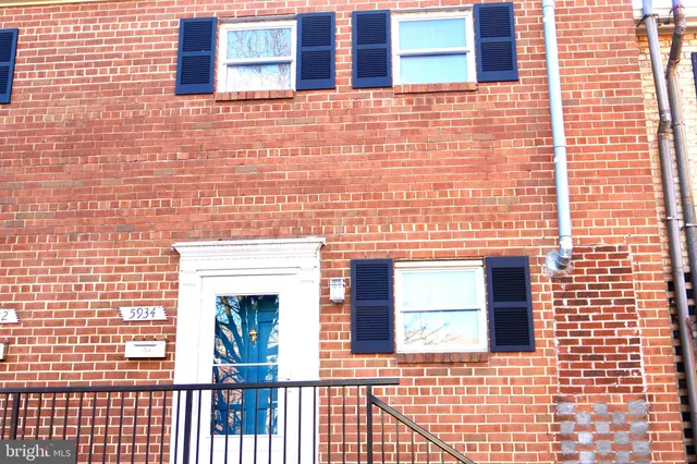 a view of a brick house with many windows