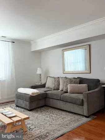 a bedroom with a bed and painting on the wall