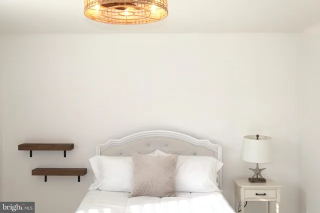 a large white bed in a white room