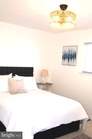 a bedroom with a bed and painting on the wall