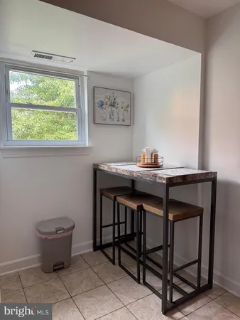 a view of a workspace with furniture and window