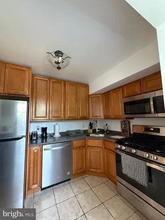 a kitchen with stainless steel appliances granite countertop a stove a sink dishwasher and a refrigerator