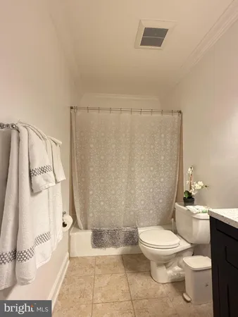a white toilet sitting next to a bathroom sink