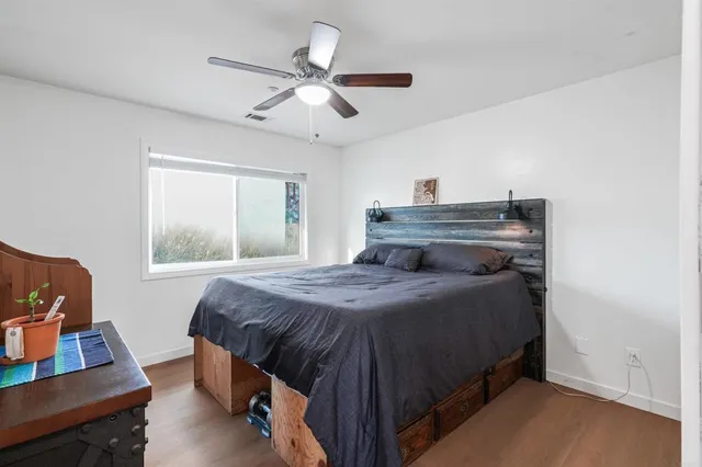 a bedroom with a bed and a window