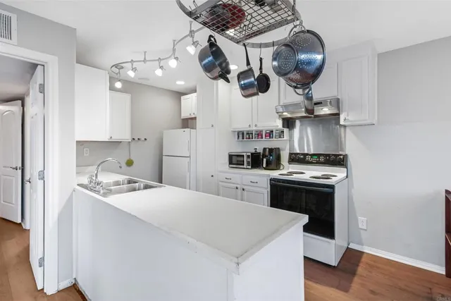 a kitchen with stainless steel appliances a stove a refrigerator and cabinets