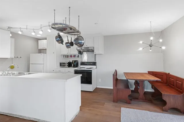 a kitchen with stainless steel appliances granite countertop a sink a stove and a refrigerator