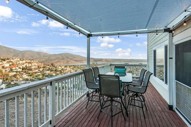 a view of a balcony with furniture and wooden floor