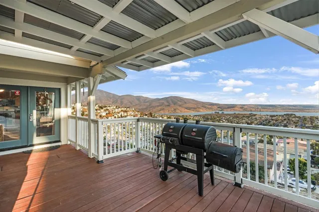 a view of a balcony with furniture and wooden floor